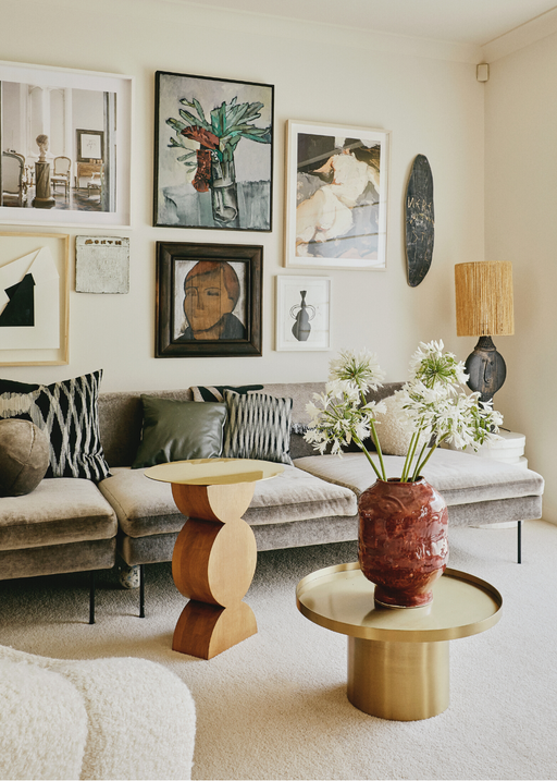 styled living room with wall art and ceramics