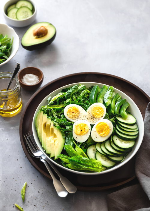 vegetarian keto bowl with cucumber, boiled eggs, avocado and lettuce