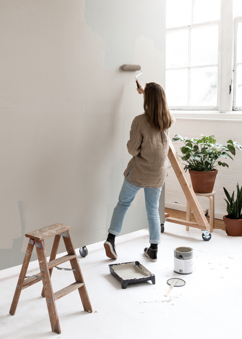 woman painting wall