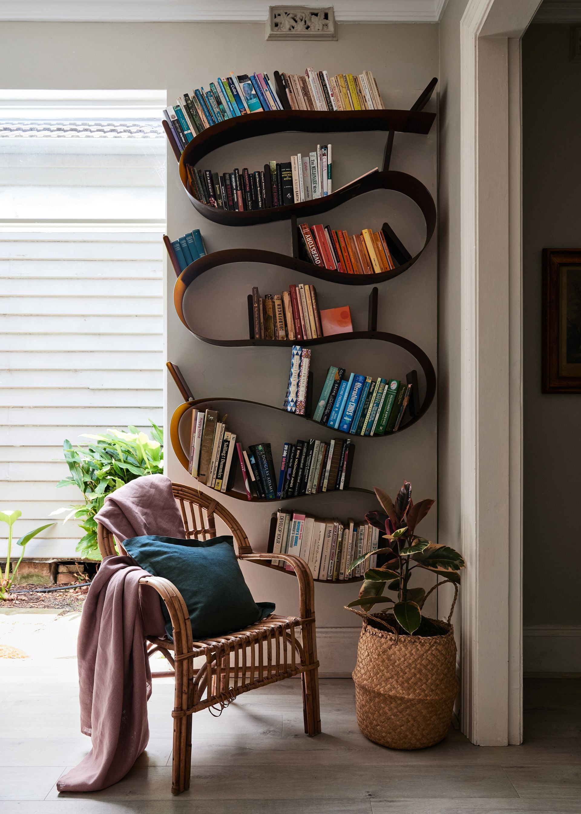 15 Floating Shelf Styling Ideas for 2026 That Elevate Modern Wall Decor 13 Wall shelves with books arranged vertically and horizontally with decor items.