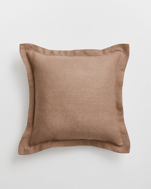 A square cushion cover in a warm taupe-brown 100% french flax linen fabric with a matching border, shown against a light grey background.