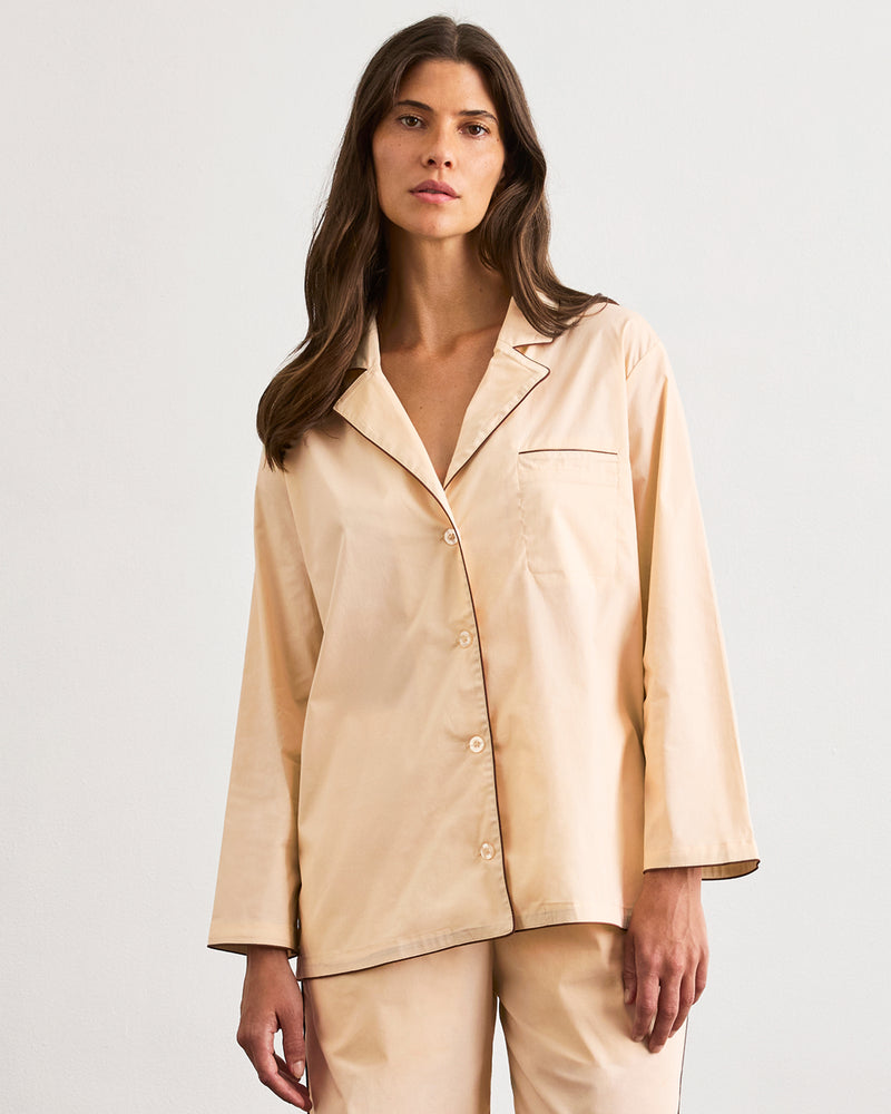 A woman with long brown hair wears the Bed Threads Vanilla & Espresso Piped Long Sleeve Shirt, posing against a plain white background and looking at the camera with a neutral expression.