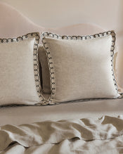 The Bed Threads Oatmeal & Charcoal 100% French Flax Linen Swirl European Pillowcases (Set of Two) add a soft, neutral touch to the bed, complementing a matching headboard and sheet for a cozy, inviting feel. - view