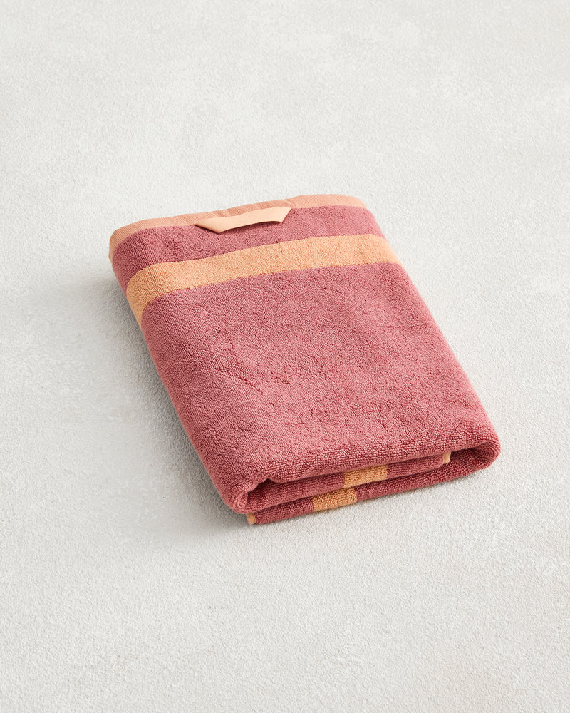 The Bed Threads Terracotta & Pink Clay Two-Toned 100% Cotton Terry Bath Towel (650GSM) features soft terry fabric and two beige stripes—ideal for anyone seeking a plush, stylish bath towel.