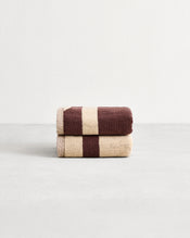 Stack of two cotton terry hand towels in reversible colours creme and cacao.  - view