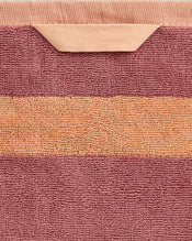 A close-up of the Bed Threads Terracotta & Pink Clay Two-Toned 100% Cotton Terry Hand Towel, showing a peach stripe and matching loop, set against muted mauve terry fabric. - view