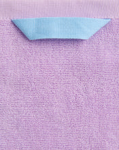 A close-up of the Bed Threads Violet 100% Cotton Terry Bath Towel Bundle shows its textured surface and a folded blue hanging loop at the top center. - view
